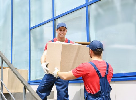 Packed moving boxes and furniture ready for house removals in an Islington property