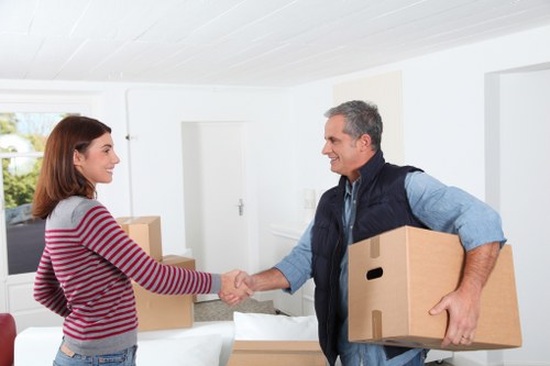 Household items being packed into a storage container for collection